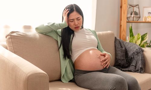 A pregnant woman suffers from pain